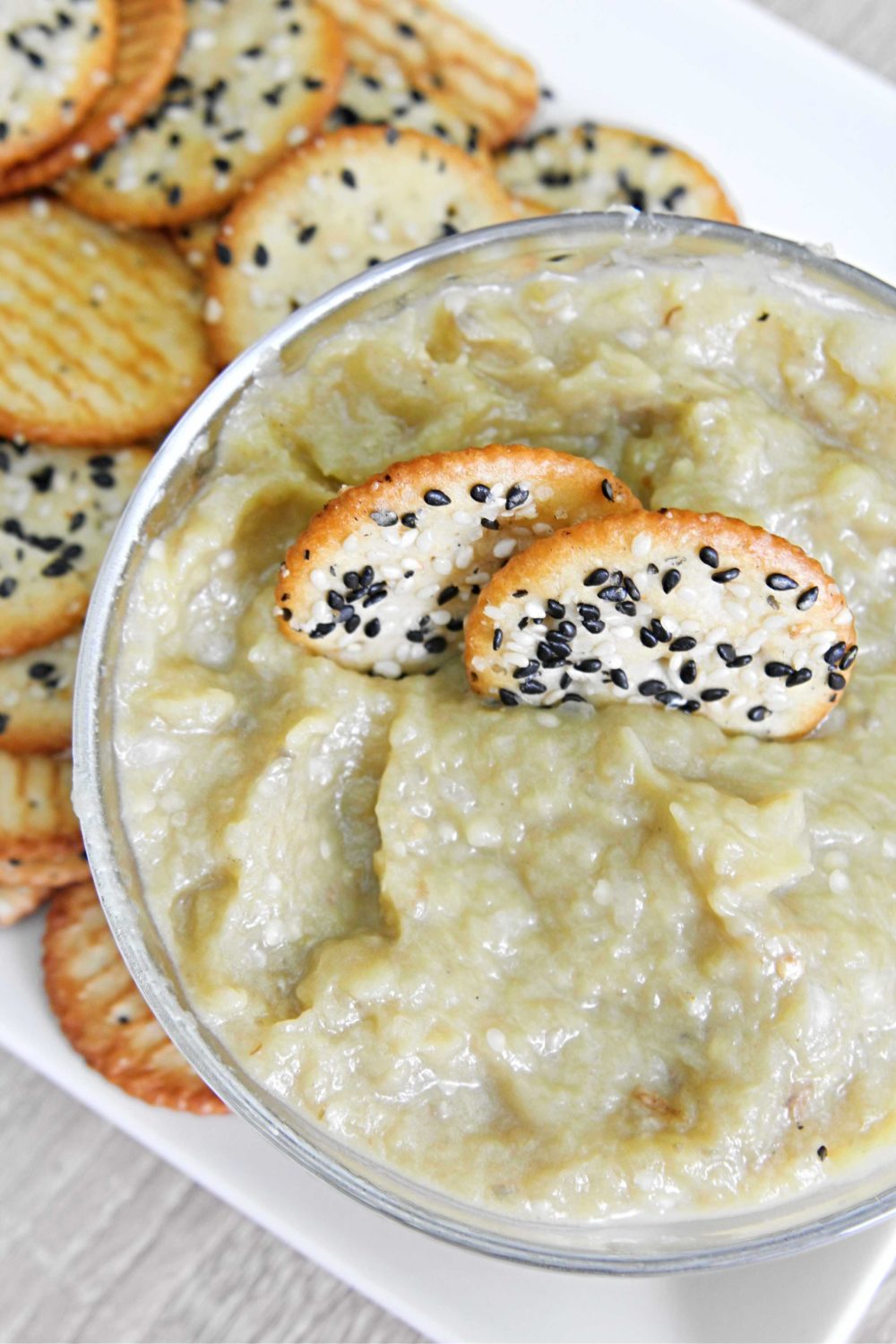 Eggplant spread with mixed seed crackers in a bowl
