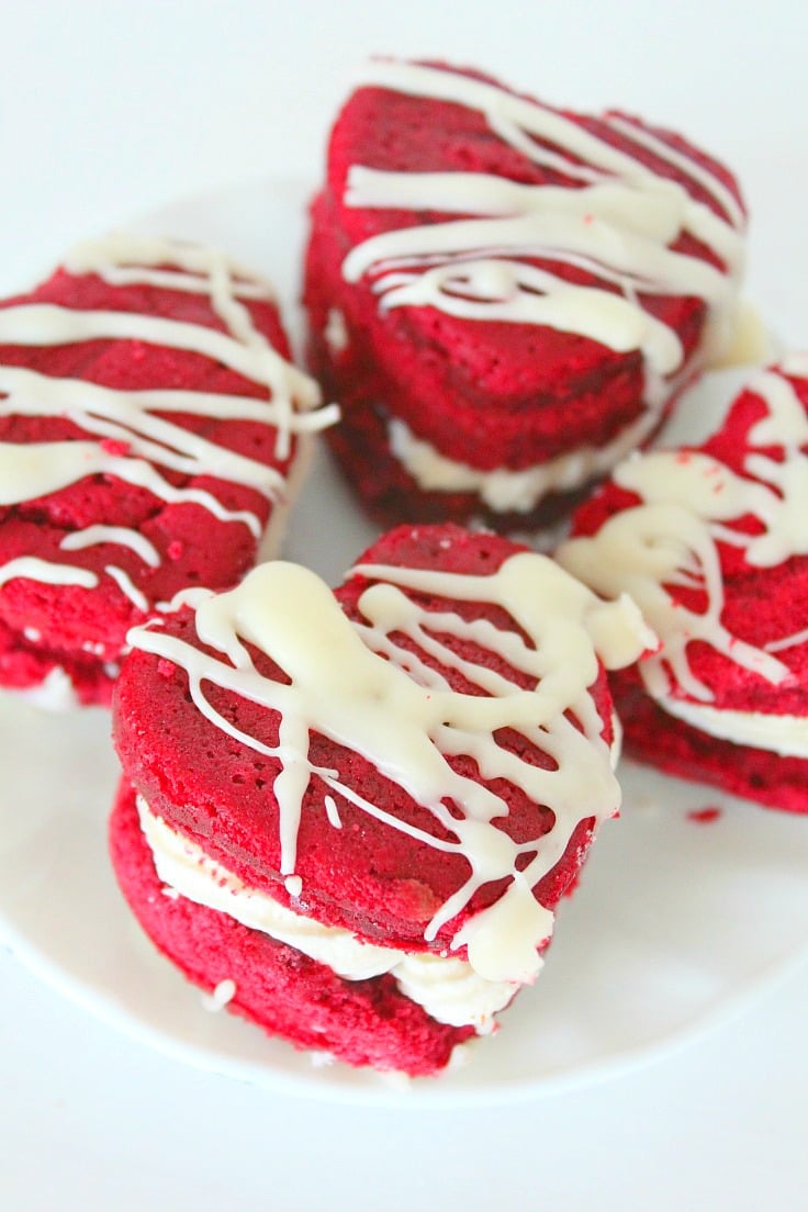 Make Valentine's Day even sweeter with these easy, adorable and delicious Red velvet sandwich cookies! Two layers of rich red velvet cake filled with decadent coconut cream cheese frosting!