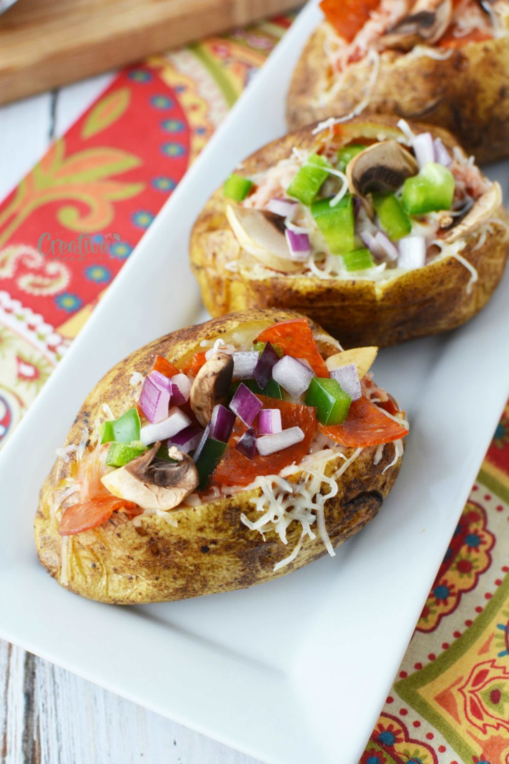 Perfect for any gatherings, parties or barbecues, these pizza baked potatoes are loaded with pepperoni, mushrooms, peppers and cheesy goodness!
