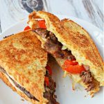 Philly cheesesteak grilled cheese with onion, red bell peppers, hot sauce and provolone cheese