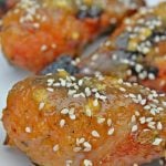 Orange chicken drumsticks baked in the oven and sprinkled with sesame seeds