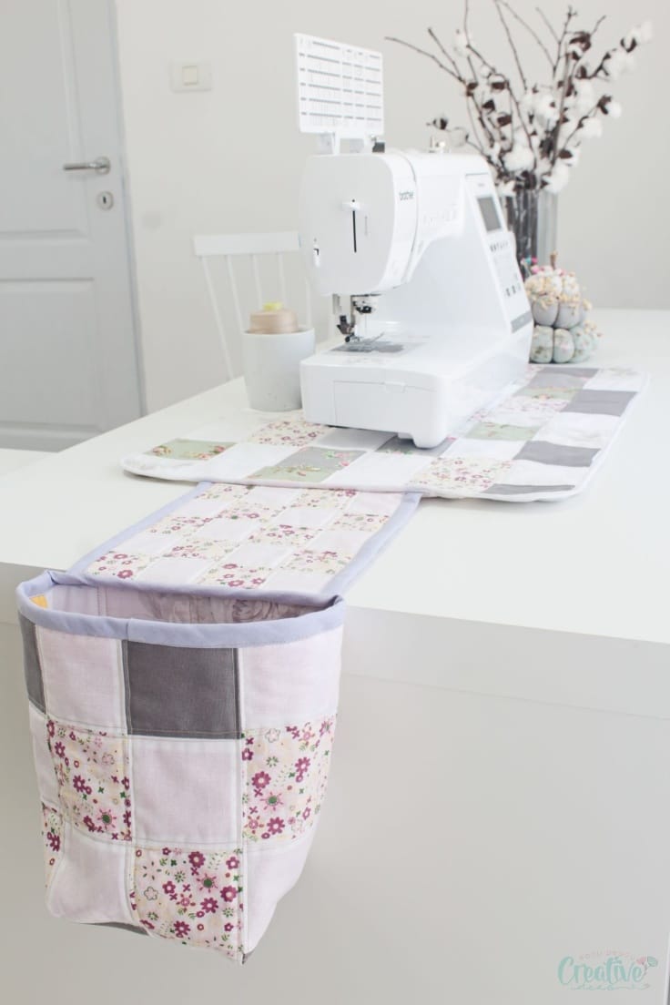 Quilted sewing mat with thread catcher