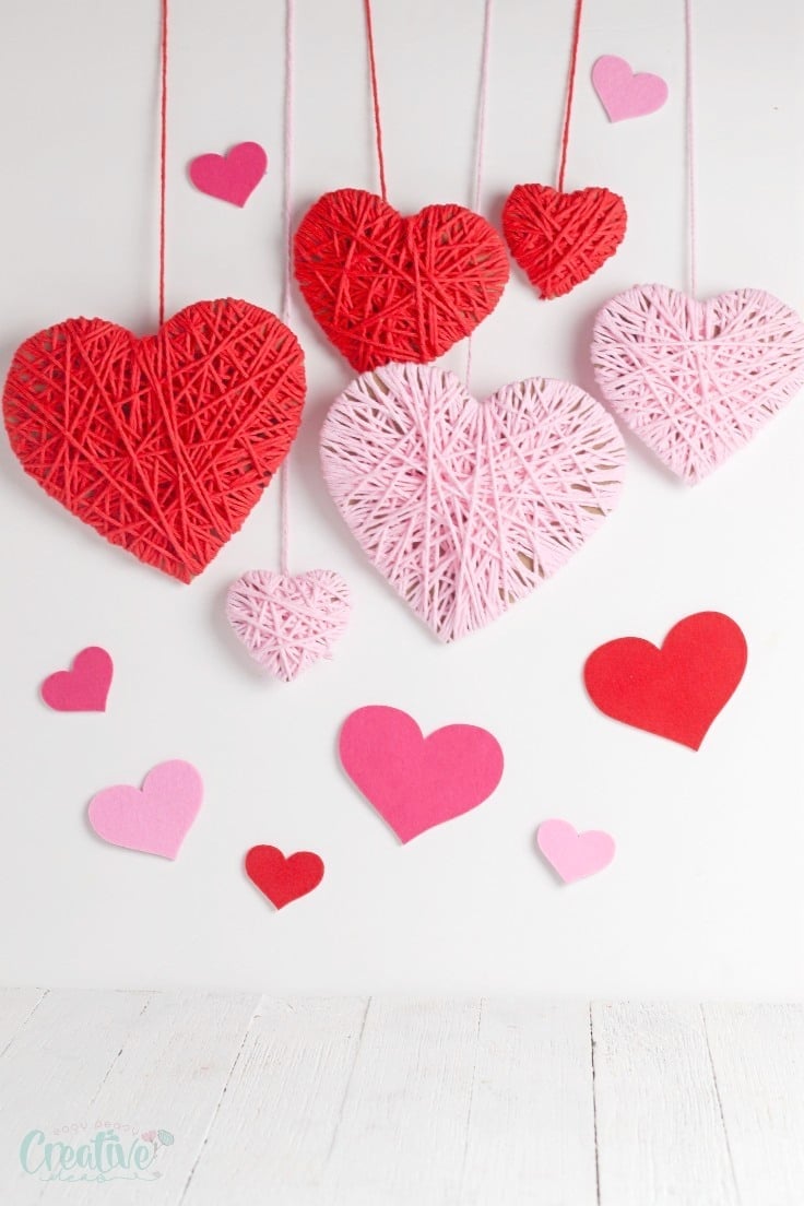 DIY Valentines backdrop with yarn hearts