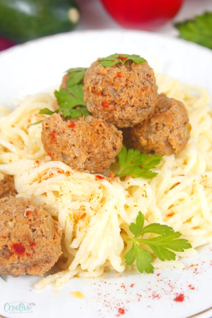 Meatballs made in the slow cooker on top of spaghetti