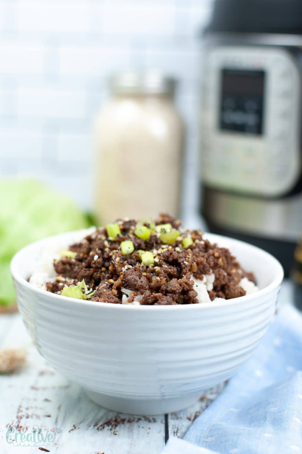 Image of a white bowl filled with Korean ground beef on rice