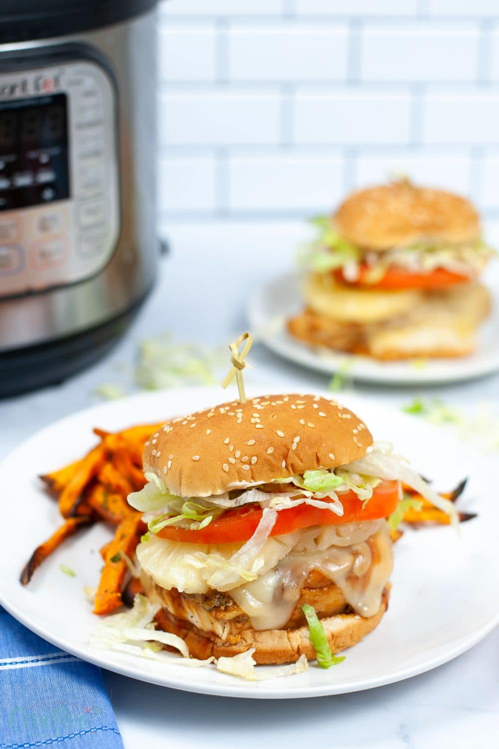 Teriyaki chicken in Instant Pot served in a burger bun on a white plate