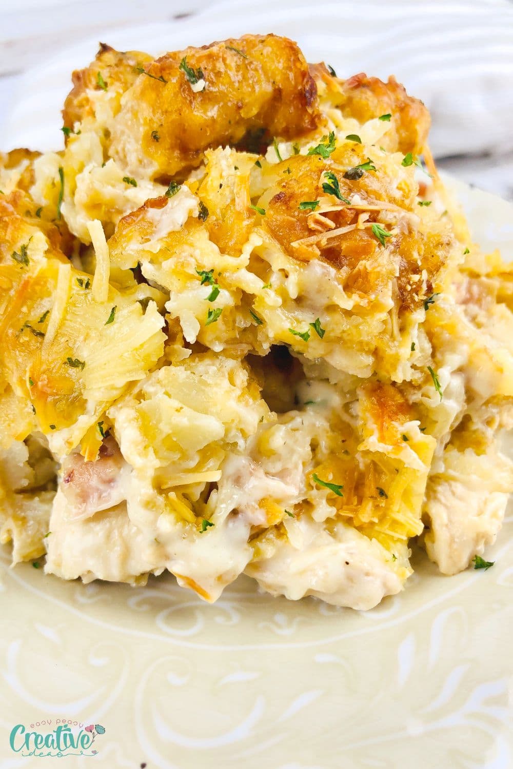 Closeup image of tater tot casserole with chicken and Alfredo sauce