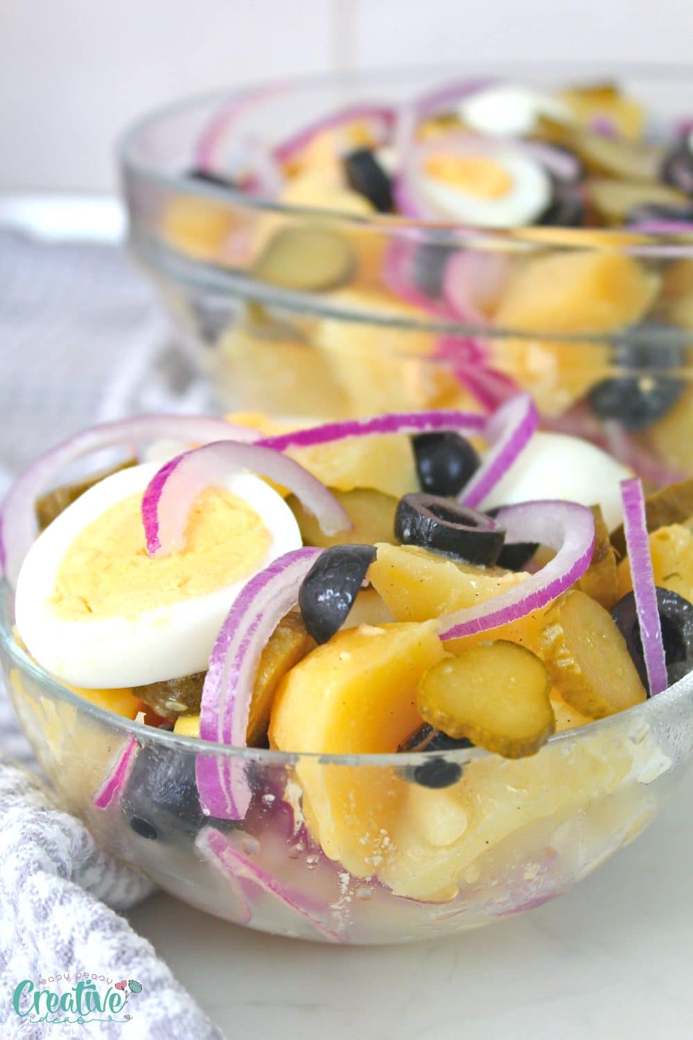 Close up image of homemade potato salad in a small serving bowl