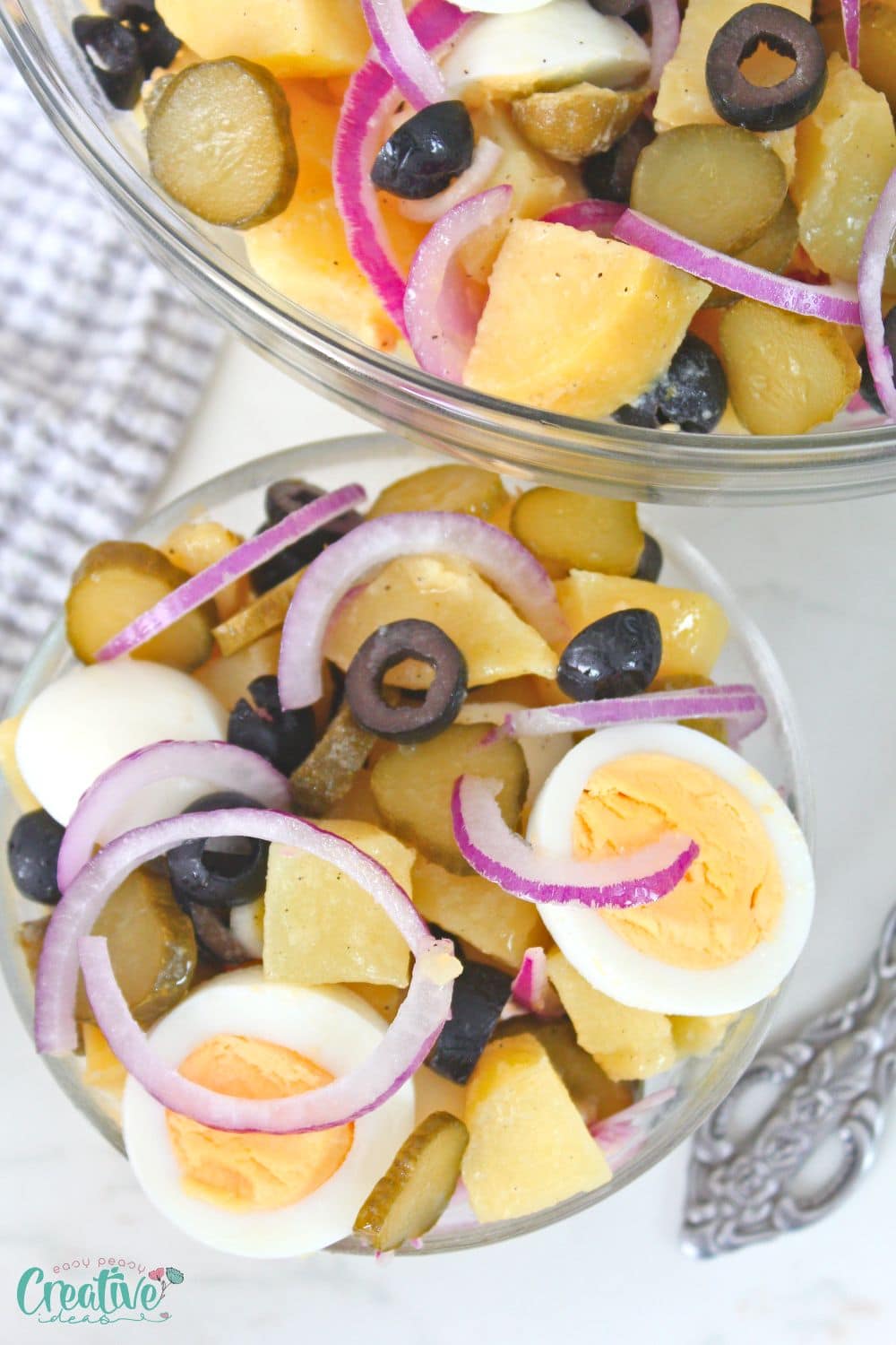 Close up image of potato and egg salad in a small serving bowl