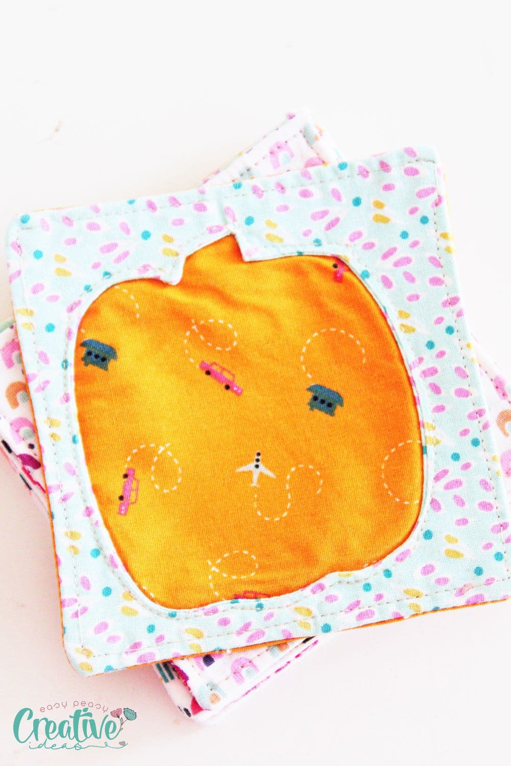 Image of a pumpkin coaster made with the reverse applique technique