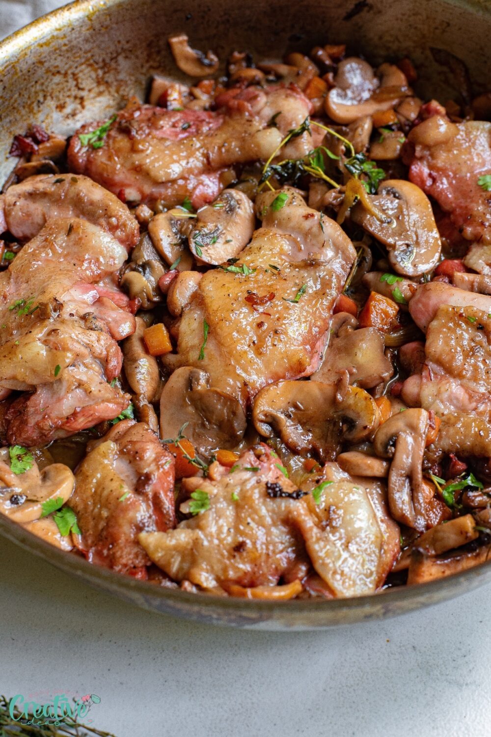 A delicious pan of bone in chicken thighs and mushrooms, cooked to perfection.