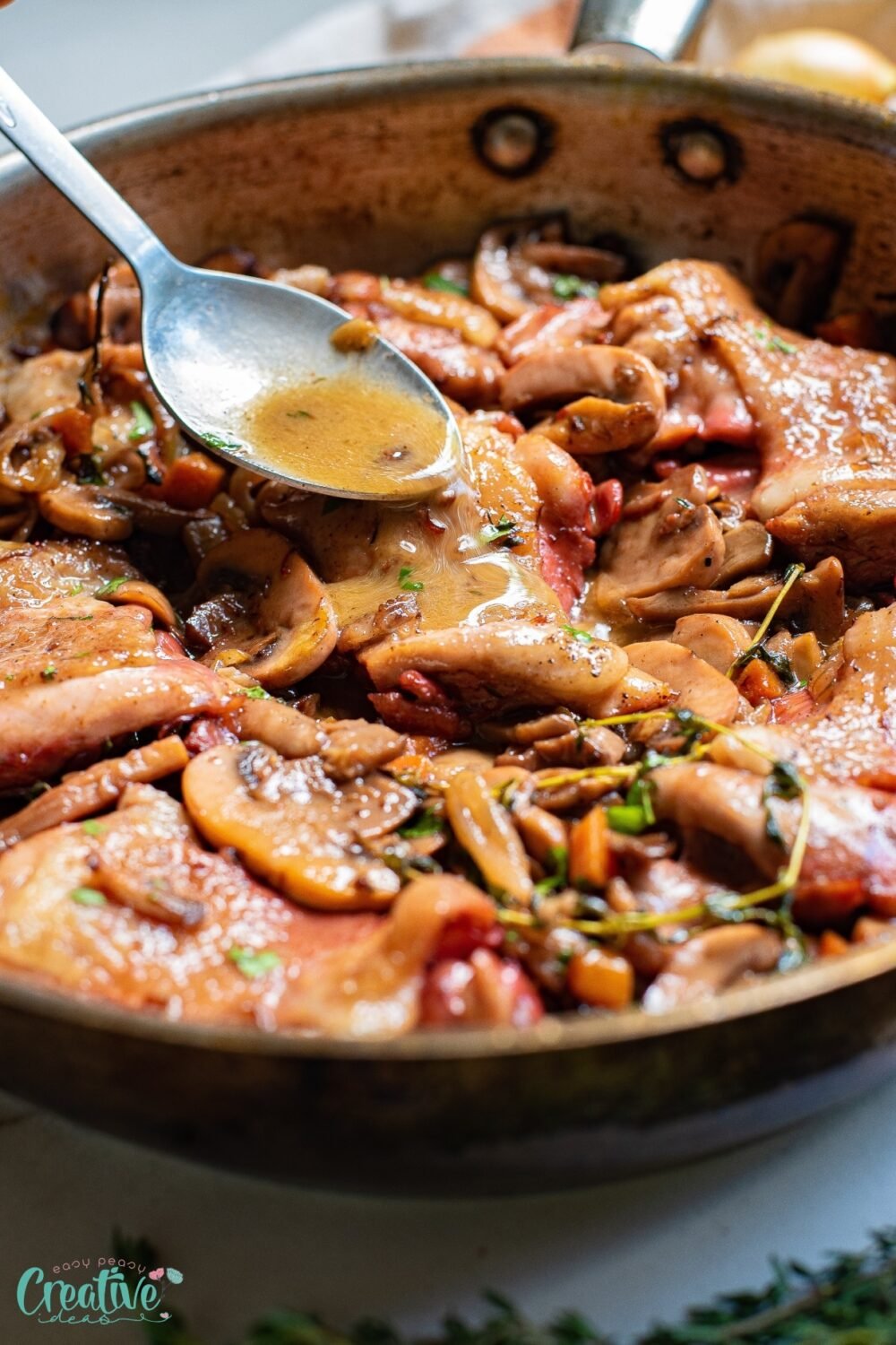 The combination of bone in skillet chicken thighs and mushrooms sizzling in a pan creates a delectable dish that is sure to make your mouth water.