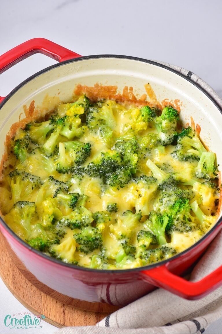 A mouthwatering chicken rice casserole with broccoli, cooked to perfection, served in a red pot for a pop of color.