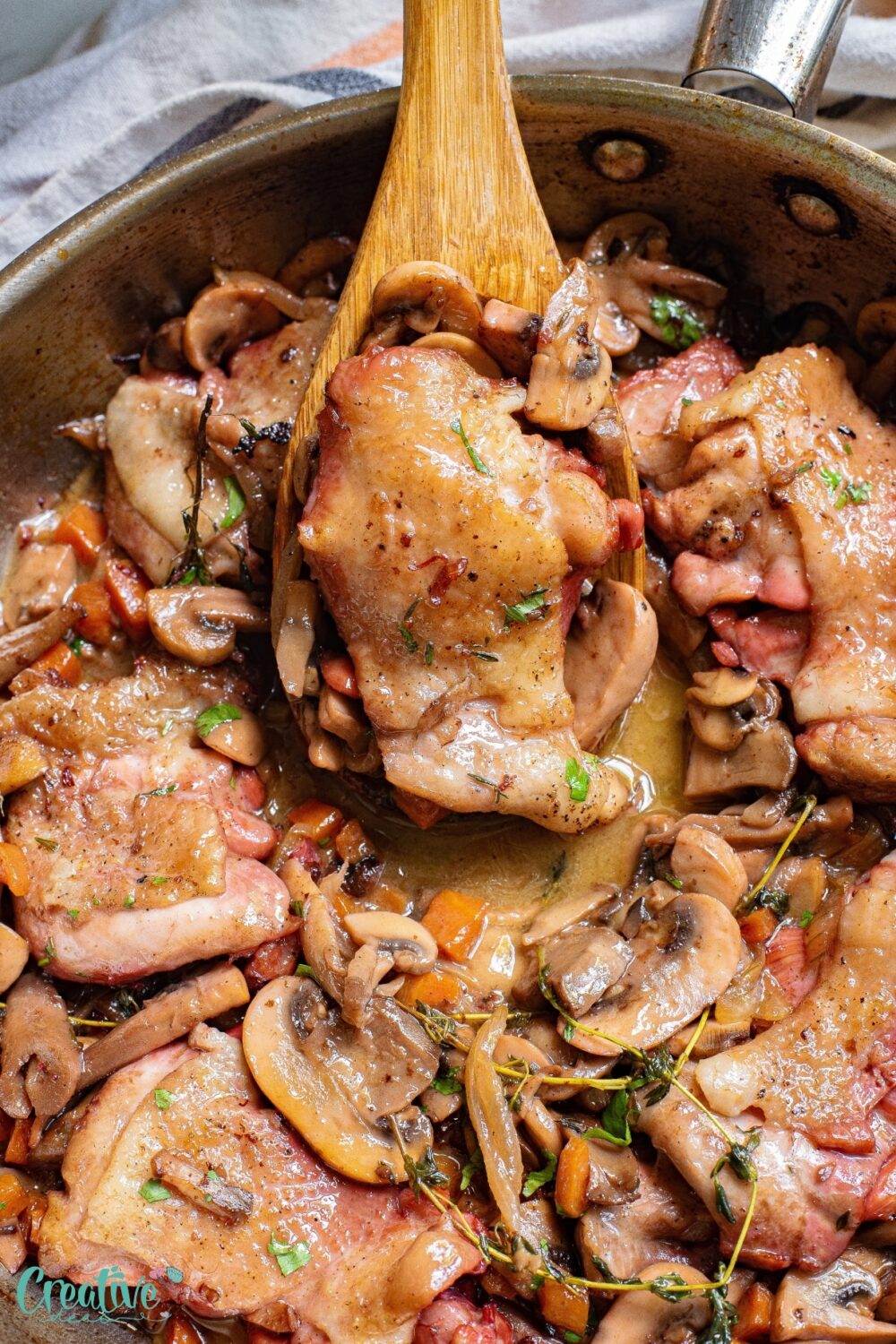 A delicious pan of chicken thighs on skillet and mushrooms sizzling together, creating a mouthwatering aroma.