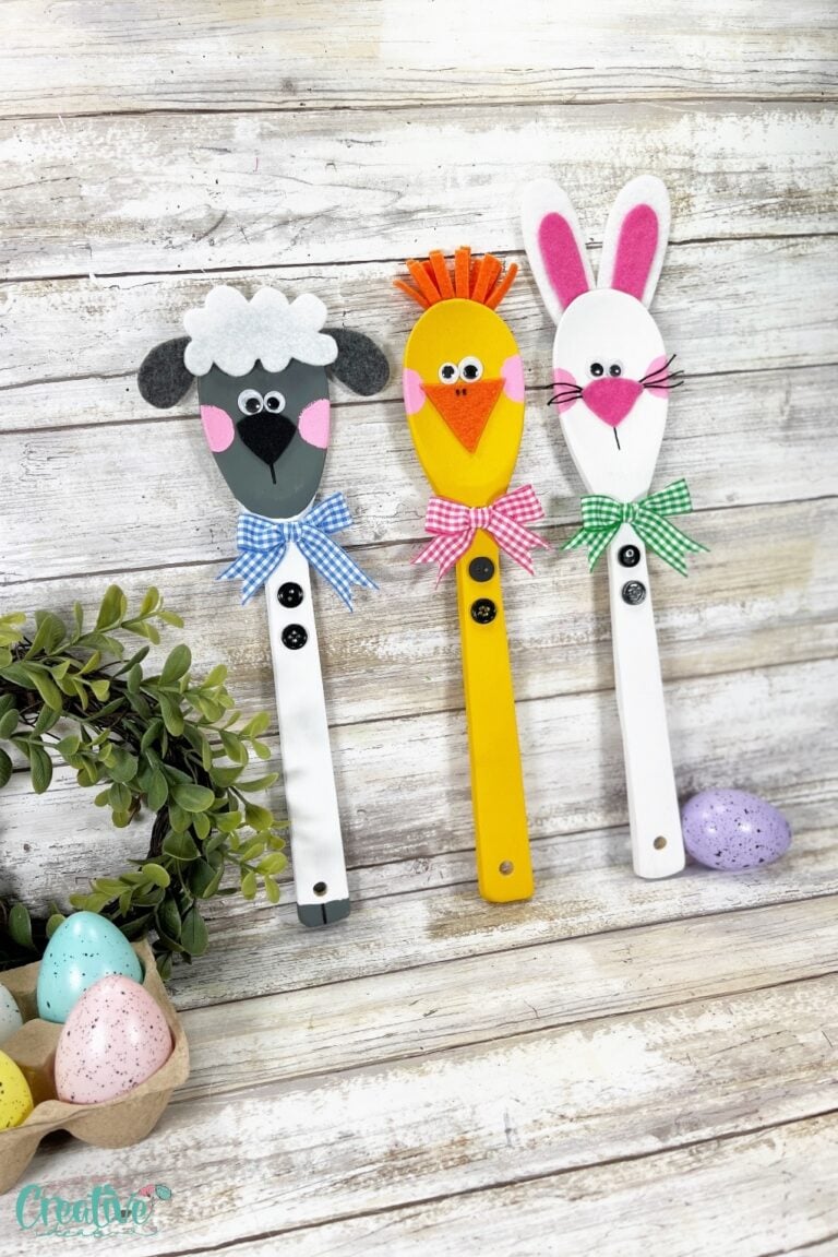 Three wooden spoons with Easter animals - a bunny, a chick, and a lamb painted on them. Cute holiday decor!
