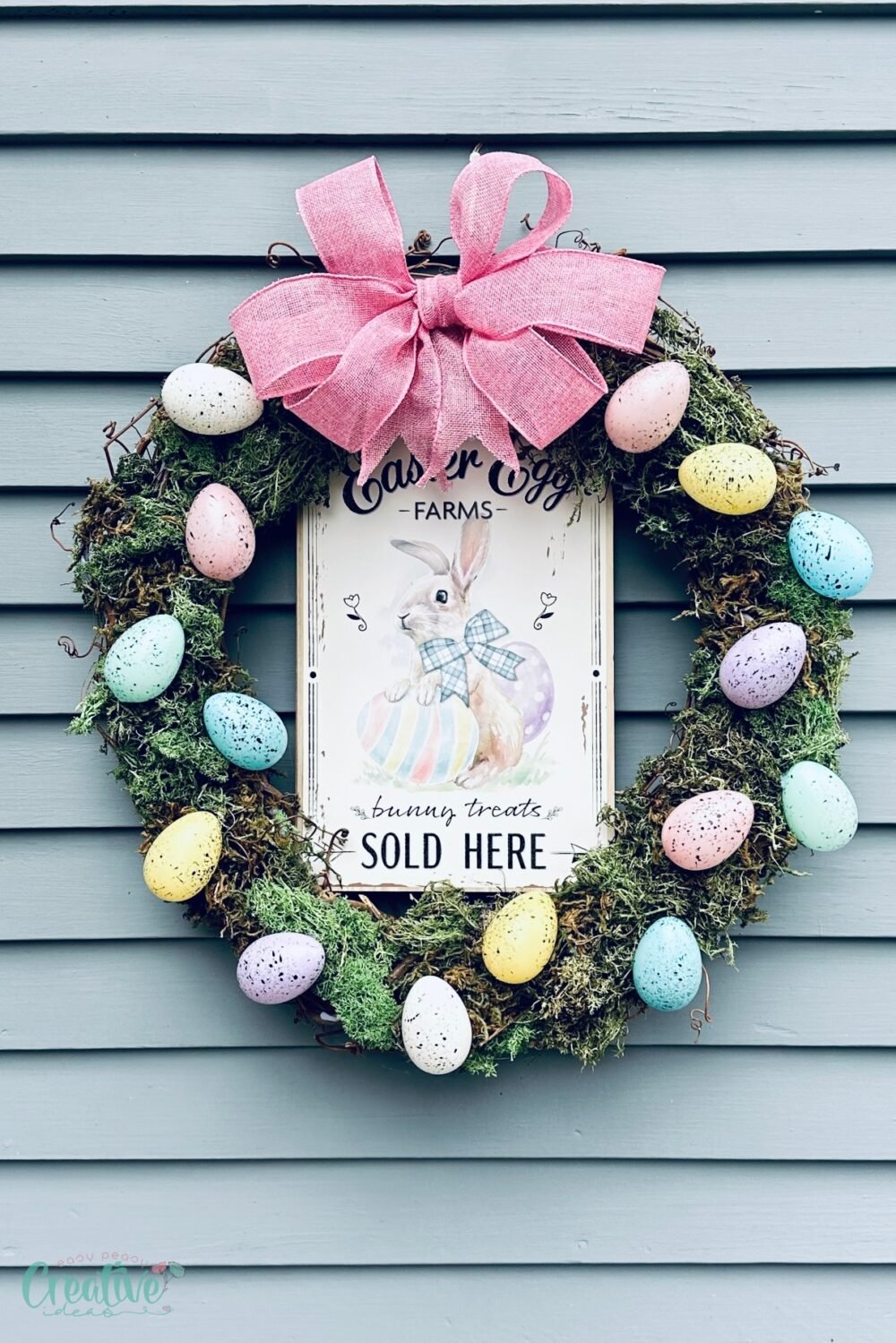 Festive Easter egg wreath adorned with eggs and a sign, ideal for holiday celebrations.