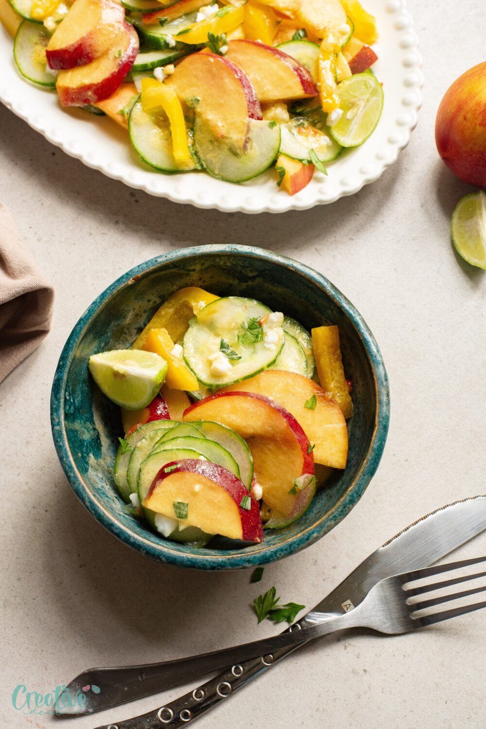 Enjoy a refreshing meal with a plate of nectarine and cucumber salad topped with a delicious dressing.