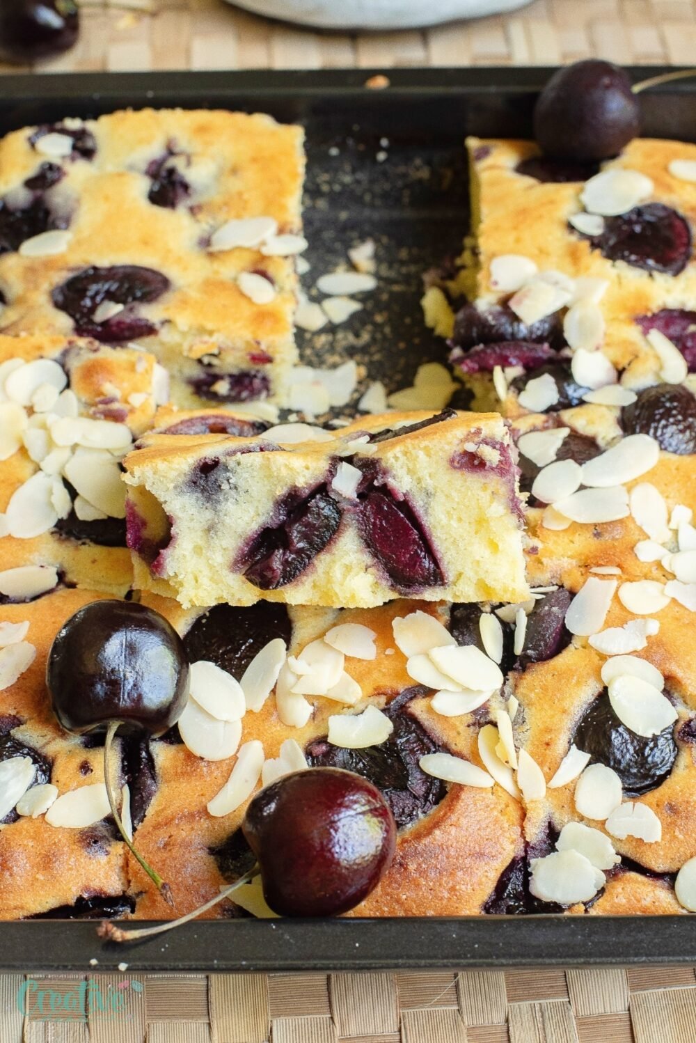 Treat yourself to a mouthwatering easy cherry cake, topped with succulent cherries and a sprinkle of crunchy almonds.