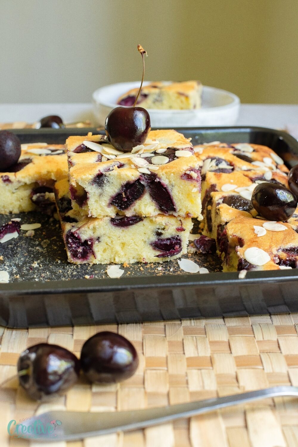 Savor the irresistible charm of a fresh cherry cake, crowned with juicy cherries and a delightful touch of almonds.
