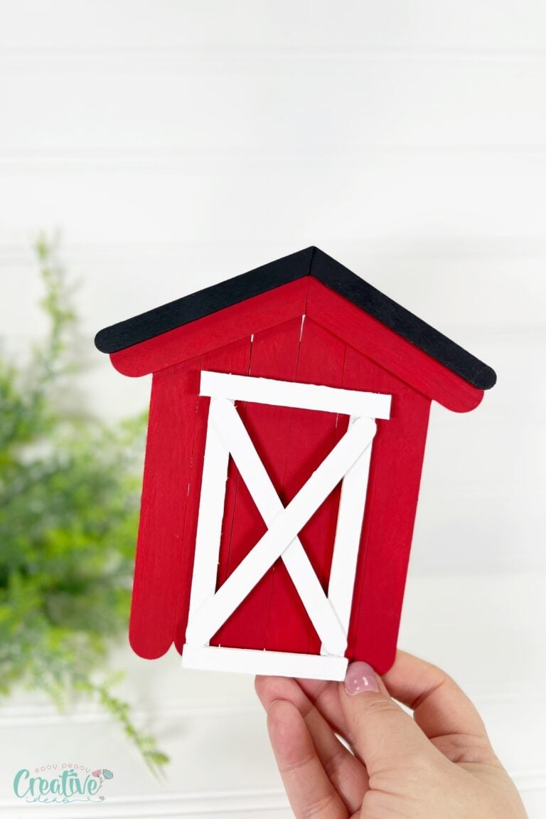 Get crafty with this mini barn craft made from craft sticks! This charming miniature project is simple to make and perfect for all skill levels.
