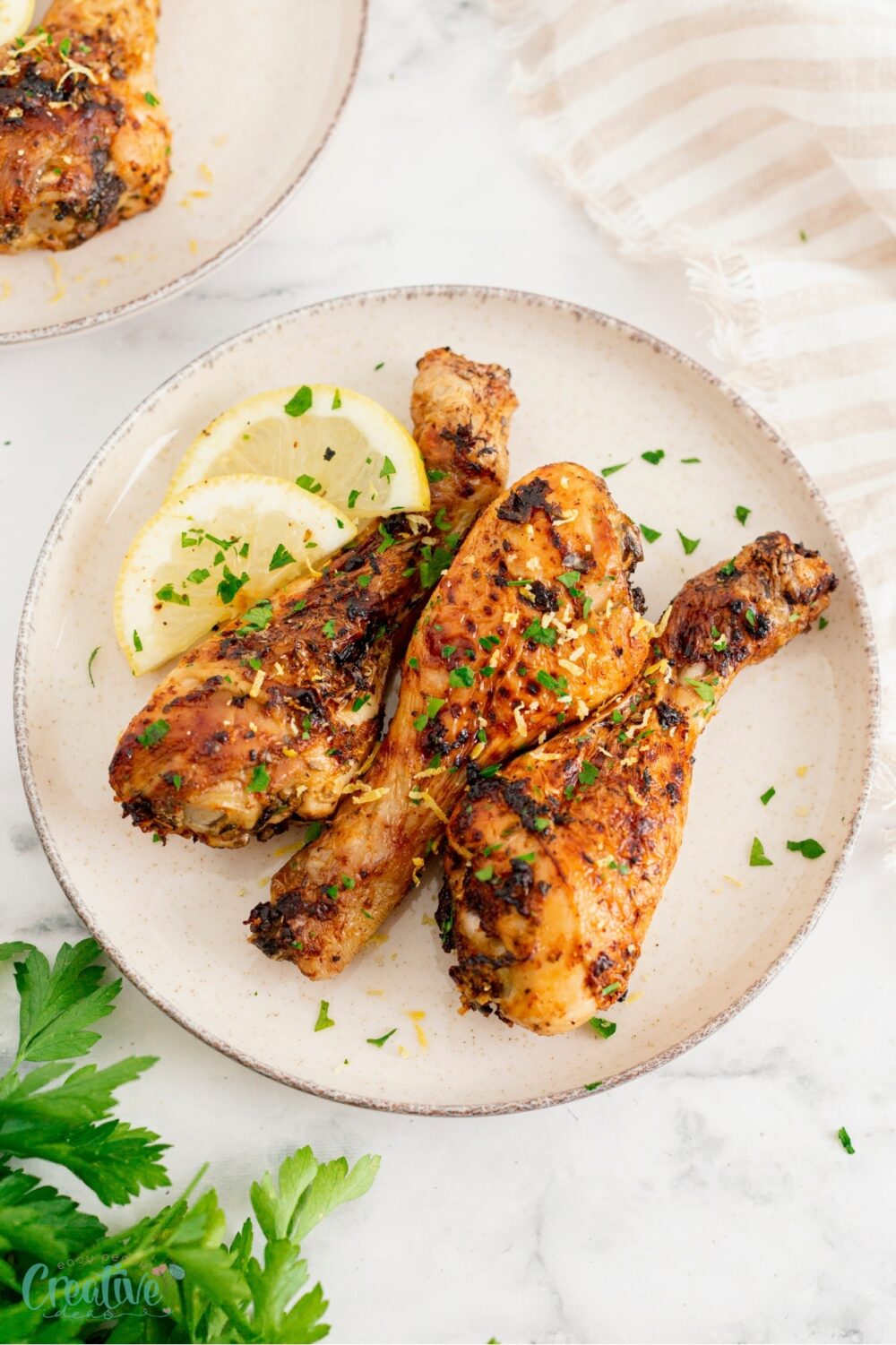 Tangy air fryer lemon garlic chicken drumsticks, a simple yet flavorful addition to any meal.