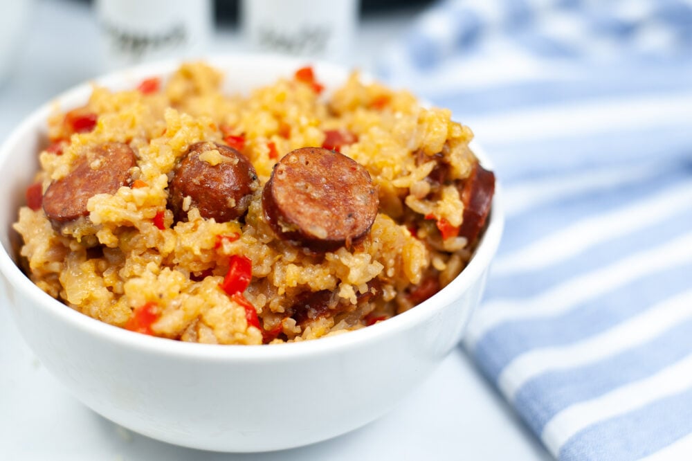 Get ready to savor a tantalizing Slow Cooker Jambalaya recipe, complete with a bowl of rice, delectable sausage, and a medley of peppers.