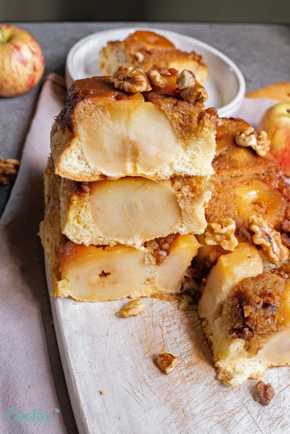 Savor the delightful warmth of an apple cake made with whole apples. Each bite unveils the juicy, tender essence of apples nestled within a moist, subtly spiced cake.