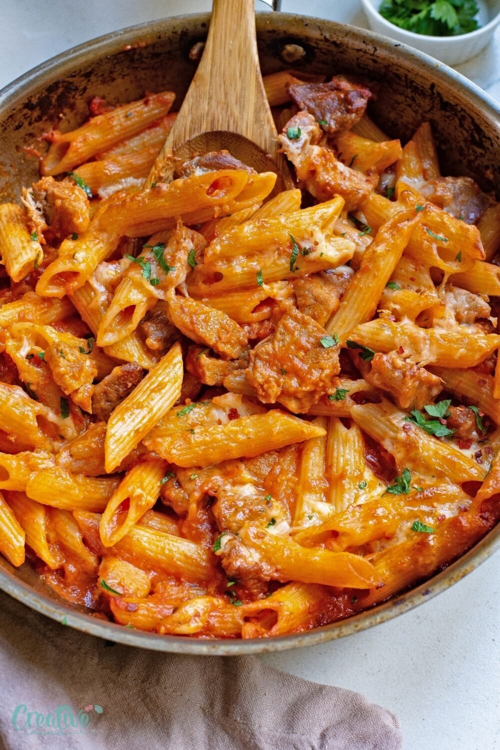 Create a delightful pasta and pork dish ideal for family dinners by pairing tender pork chops with savory pasta in a luscious marinara sauce.