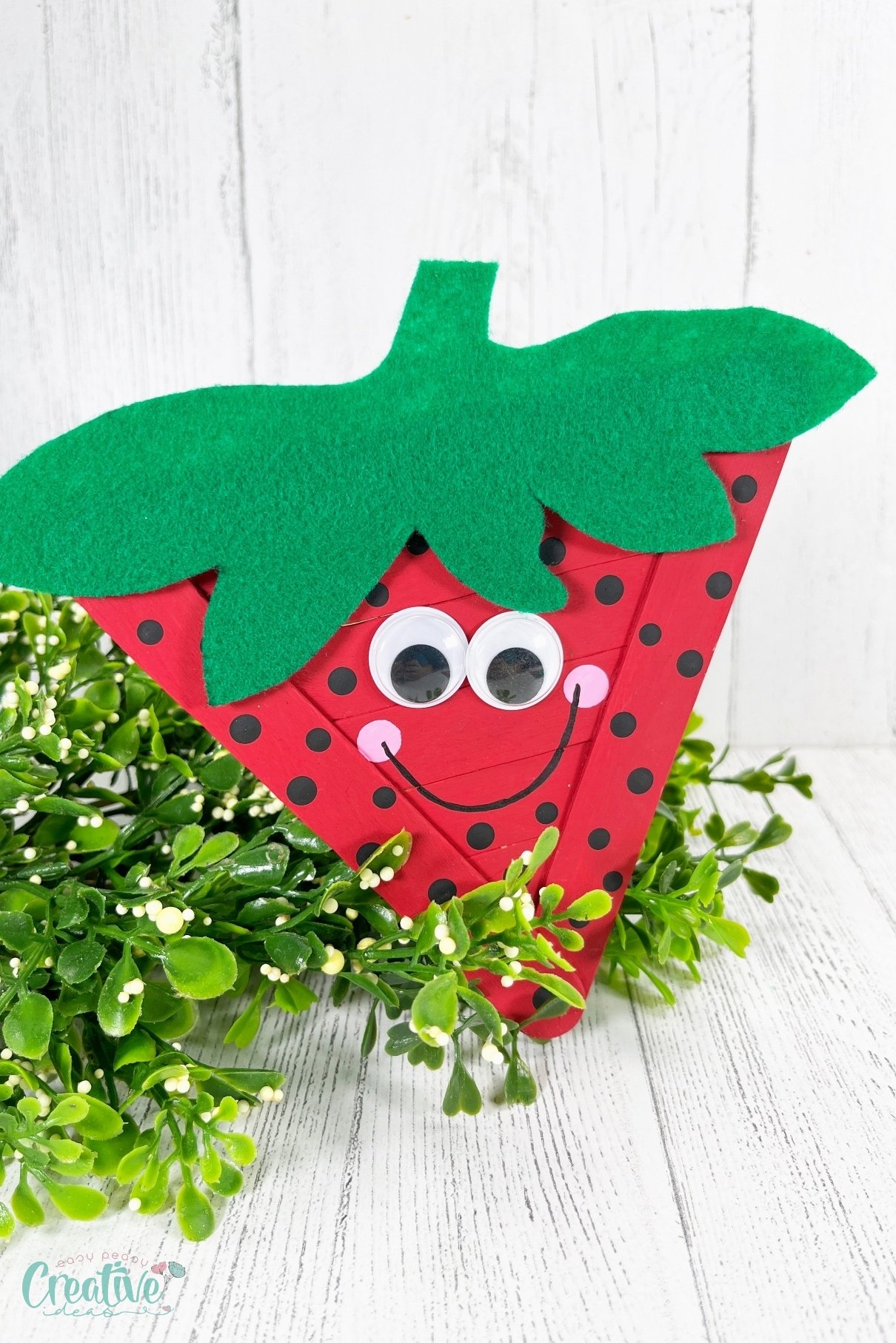 The simplicity of using jumbo craft sticks as the base structure makes this strawberry craft sturdy and easy to handle.